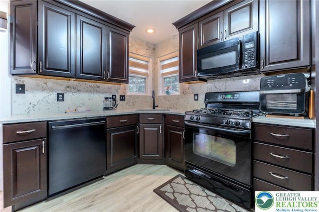 1536 Cambridge Dr, Lower Macungie Twp, PA 18062 - kitchen with black appliances, light wood-type flooring, decorative backsplash, and dark brown cabinetry