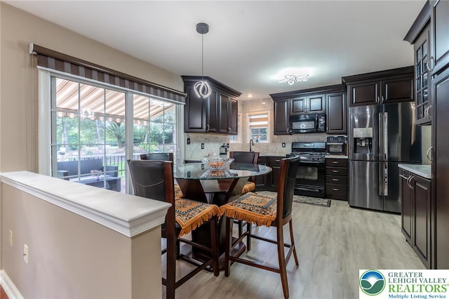 1536 Cambridge Dr, Lower Macungie Twp, PA 18062 - kitchen featuring black appliances, light wood-type flooring, tasteful backsplash, and decorative light fixtures