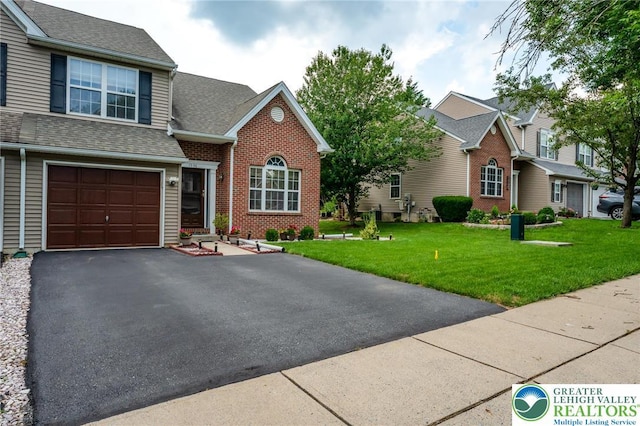 1536 Cambridge Dr, Lower Macungie Twp, PA 18062 - view of front of house featuring brick siding, a front yard, asphalt driveway, roof with shingles, and an attached garage