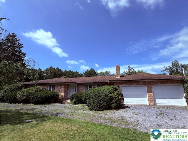 4395 E Texas Rd, Lower Macungie Twp, PA 18103 - ranch-style home featuring a garage, a chimney, gravel driveway, a front lawn, and brick siding