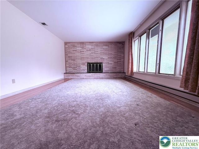 4395 E Texas Rd, Lower Macungie Twp, PA 18103 - unfurnished living room with a baseboard radiator, a fireplace, and wood finished floors