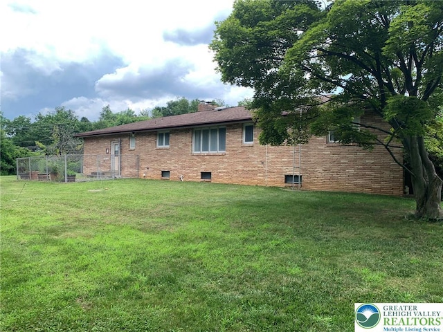 4395 E Texas Rd, Lower Macungie Twp, PA 18103 - view of side of home featuring a yard, brick siding, and a chimney