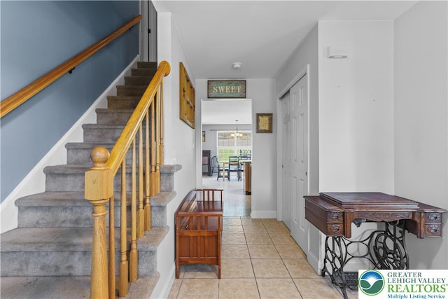 7725 Harbor Ct, Washington Twp, PA 18080 - staircase featuring tile patterned floors and a chandelier