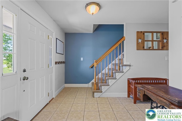 7725 Harbor Ct, Washington Twp, PA 18080 - entrance foyer featuring healthy amount of natural light, light tile patterned floors, and stairway