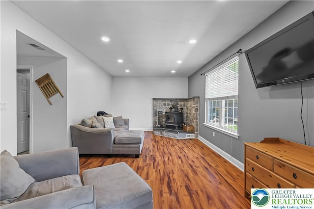 7725 Harbor Ct, Washington Twp, PA 18080 - living area featuring a wood stove, wood finished floors, and recessed lighting