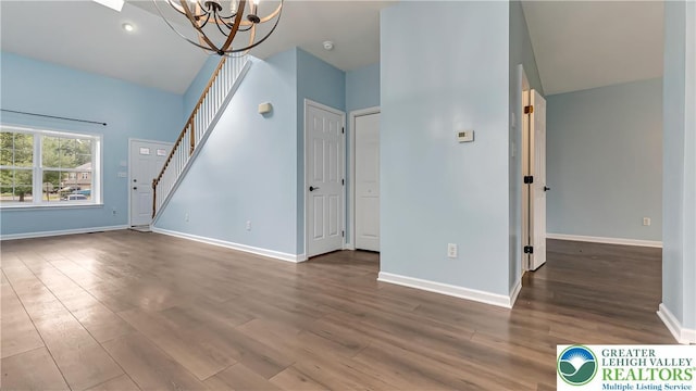 5587 Stonecroft Ln, Lower Macungie Twp, PA 18106 - unfurnished living room featuring a chandelier, wood finished floors, and stairway