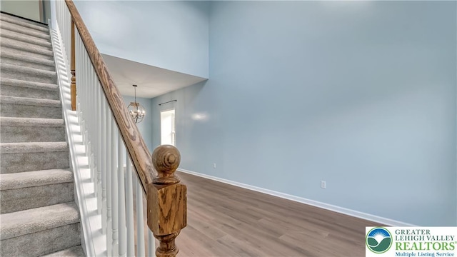5587 Stonecroft Ln, Lower Macungie Twp, PA 18106 - stairs with wood finished floors and a chandelier
