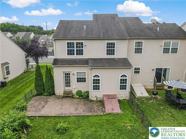 5587 Stonecroft Ln, Lower Macungie Twp, PA 18106 - back of property featuring entry steps, a patio area, and a fenced backyard