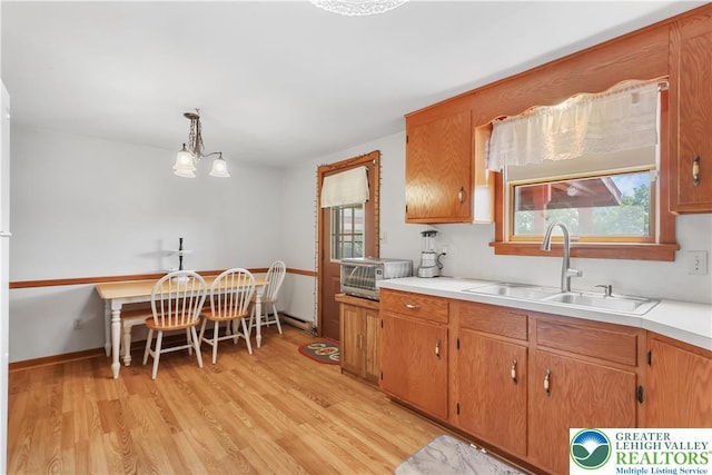 5396 Nor Bath Blvd, East Allen Twp, PA 18067 - kitchen with light wood finished floors, light countertops, brown cabinetry, and decorative light fixtures