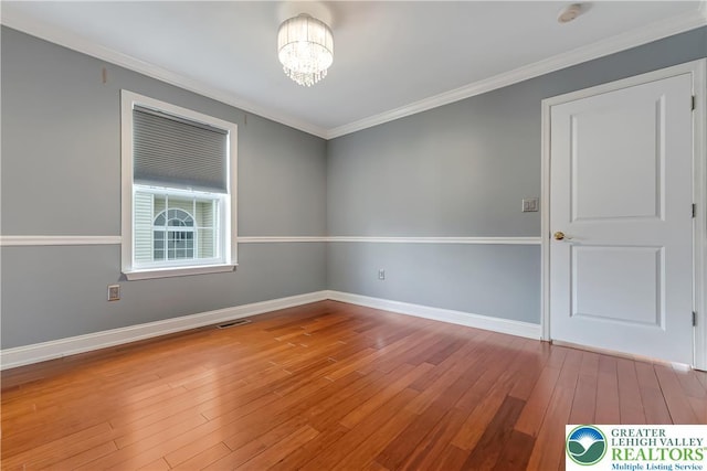 6945 Hunt Dr, Lower Macungie Twp, PA 18062 - empty room with a chandelier, wood-type flooring, crown molding, and a smoke detector