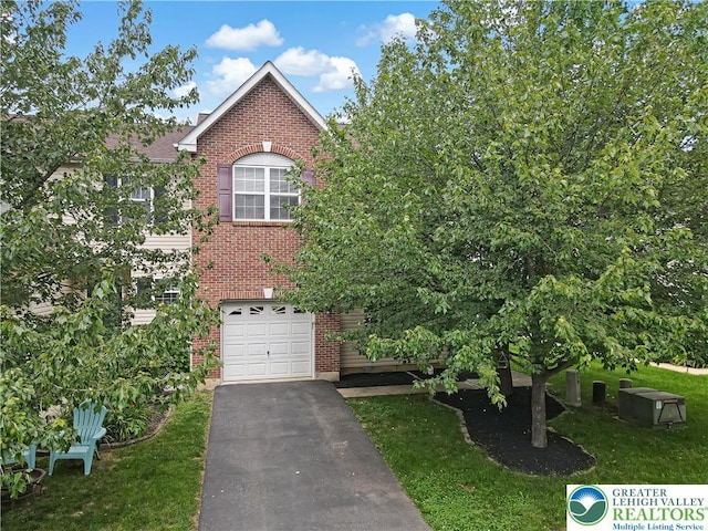 6945 Hunt Dr, Lower Macungie Twp, PA 18062 - view of front of house featuring brick siding, driveway, a garage, and a front yard