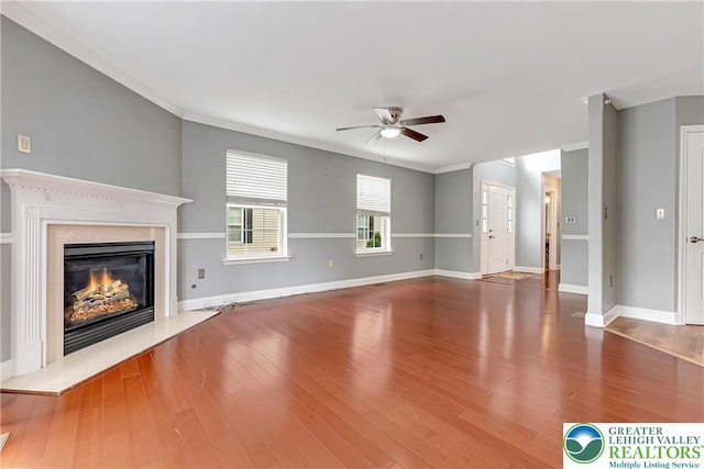 6945 Hunt Dr, Lower Macungie Twp, PA 18062 - unfurnished living room featuring ceiling fan, crown molding, a premium fireplace, and wood finished floors