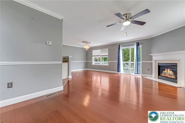 6945 Hunt Dr, Lower Macungie Twp, PA 18062 - unfurnished living room featuring crown molding, a fireplace with flush hearth, a ceiling fan, and wood finished floors