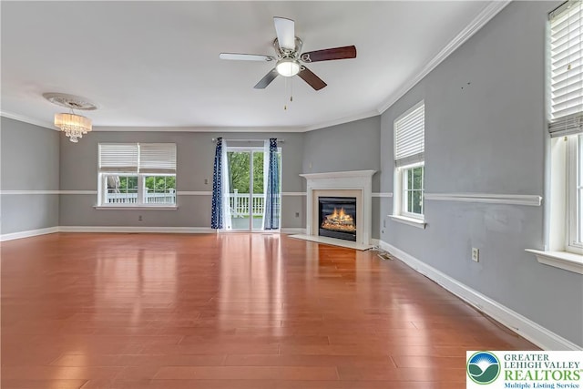 6945 Hunt Dr, Lower Macungie Twp, PA 18062 - unfurnished living room featuring ornamental molding, a fireplace with flush hearth, ceiling fan, a chandelier, and wood finished floors