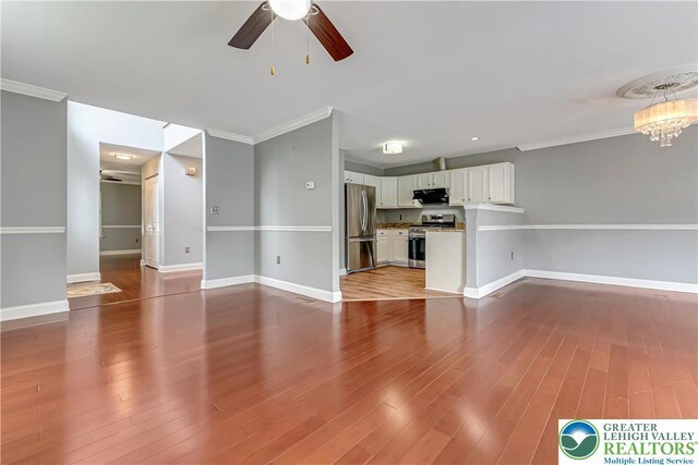 6945 Hunt Dr, Lower Macungie Twp, PA 18062 - unfurnished living room featuring ceiling fan, ornamental molding, a chandelier, and wood finished floors