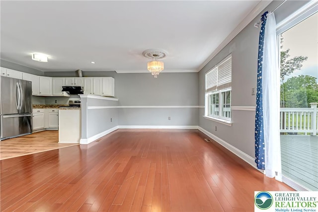6945 Hunt Dr, Lower Macungie Twp, PA 18062 - unfurnished living room featuring wood finished floors, ornamental molding, and a chandelier