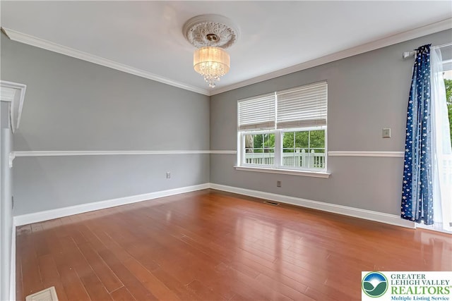 6945 Hunt Dr, Lower Macungie Twp, PA 18062 - unfurnished room featuring wood finished floors, ornamental molding, and a chandelier