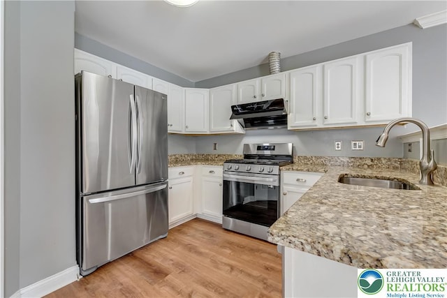 6945 Hunt Dr, Lower Macungie Twp, PA 18062 - kitchen featuring stainless steel appliances, exhaust hood, white cabinetry, and light stone countertops