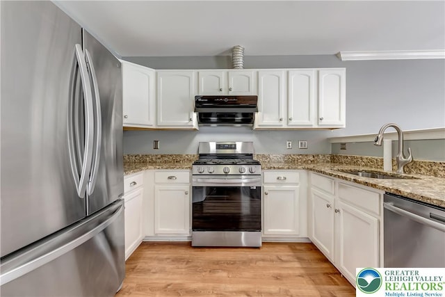 6945 Hunt Dr, Lower Macungie Twp, PA 18062 - kitchen featuring appliances with stainless steel finishes, range hood, white cabinets, and light stone counters