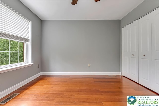 6945 Hunt Dr, Lower Macungie Twp, PA 18062 - unfurnished bedroom with light wood-style floors, a closet, and a ceiling fan