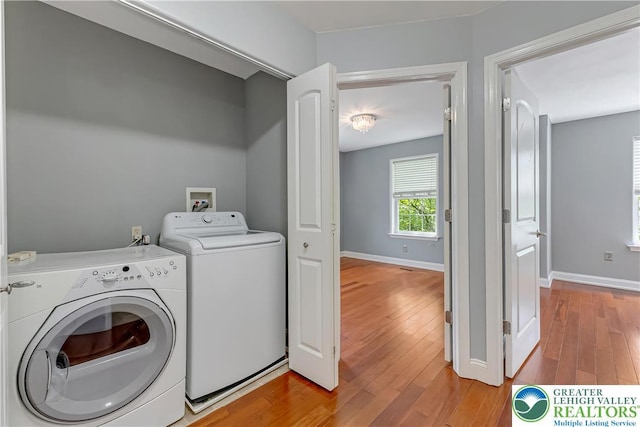 6945 Hunt Dr, Lower Macungie Twp, PA 18062 - laundry area with washing machine and dryer and light wood-style flooring