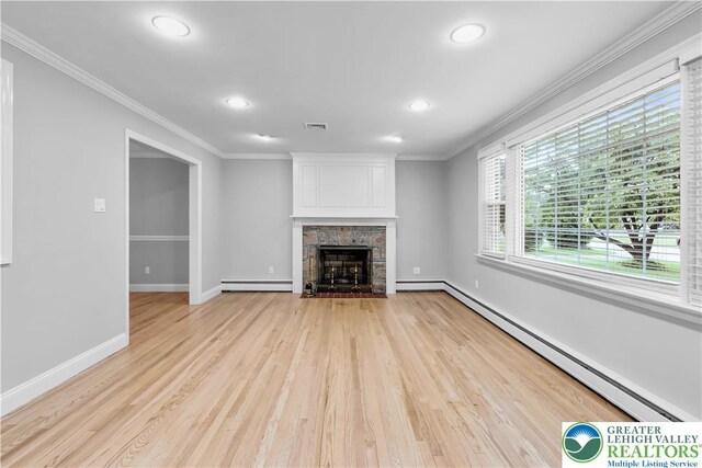 3032 W Woodlawn St, South Whitehall Twp, PA 18104 - unfurnished living room featuring a baseboard heating unit, a baseboard radiator, recessed lighting, ornamental molding, and light wood-style flooring
