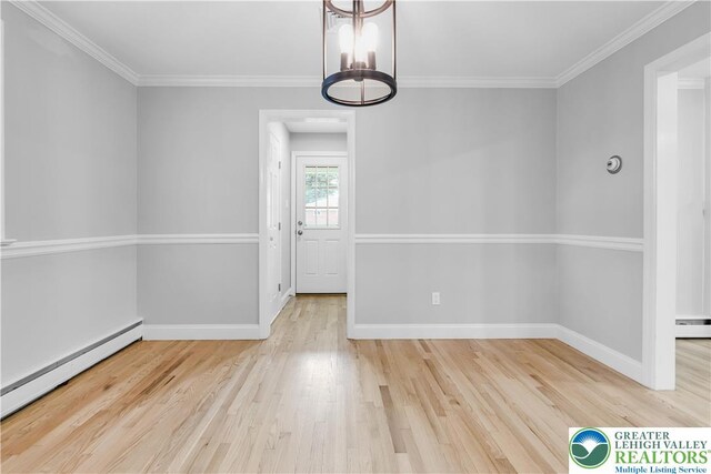 3032 W Woodlawn St, South Whitehall Twp, PA 18104 - unfurnished dining area with baseboard heating, wood finished floors, a chandelier, crown molding, and a baseboard heating unit