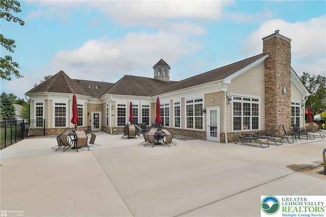 4076 Pine Hurst Dr, Allen Twp, PA 18067 - back of property featuring a patio, stone siding, and a chimney
