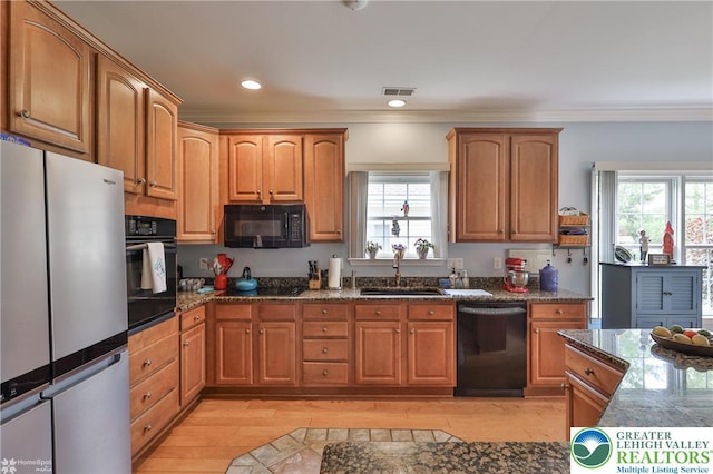 4076 Pine Hurst Dr, Allen Twp, PA 18067 - kitchen featuring black appliances, light wood-style flooring, ornamental molding, healthy amount of natural light, and recessed lighting