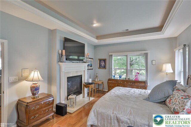 4076 Pine Hurst Dr, Allen Twp, PA 18067 - bedroom with wood finished floors, a premium fireplace, and a raised ceiling