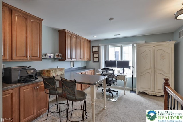 4076 Pine Hurst Dr, Allen Twp, PA 18067 - kitchen with a desk, light carpet, dark countertops, brown cabinets, and recessed lighting