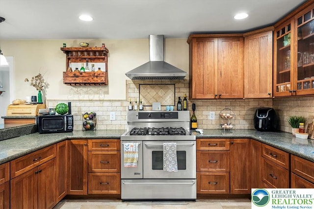 1079 Marshalls Creek Rd, Middle Smithfield Twp, PA 18302 - kitchen with wall chimney exhaust hood, range with two ovens, black microwave, and brown cabinetry