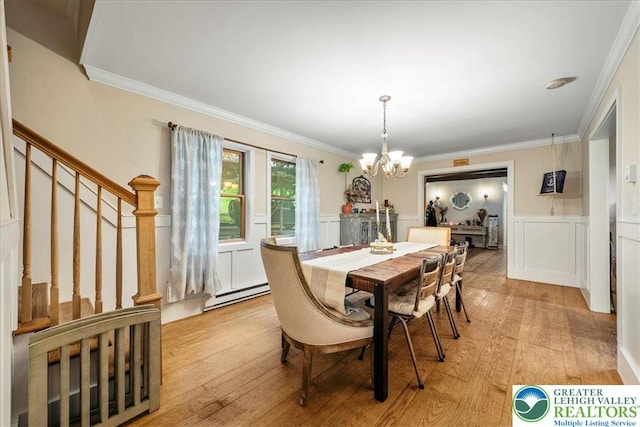 1079 Marshalls Creek Rd, Middle Smithfield Twp, PA 18302 - dining area featuring a chandelier, baseboard heating, light wood-type flooring, ornamental molding, and a decorative wall