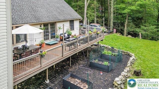 1079 Marshalls Creek Rd, Middle Smithfield Twp, PA 18302 - wooden terrace featuring a vegetable garden, a lawn, and outdoor dining area