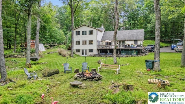 1079 Marshalls Creek Rd, Middle Smithfield Twp, PA 18302 - back of house with an outdoor fire pit, a wooden deck, a yard, and a chimney