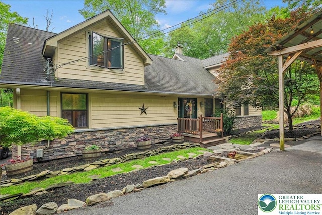1079 Marshalls Creek Rd, Middle Smithfield Twp, PA 18302 - view of front of property featuring a shingled roof, stone siding, and a chimney