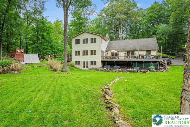 1079 Marshalls Creek Rd, Middle Smithfield Twp, PA 18302 - back of house with a deck, a yard, and a chimney