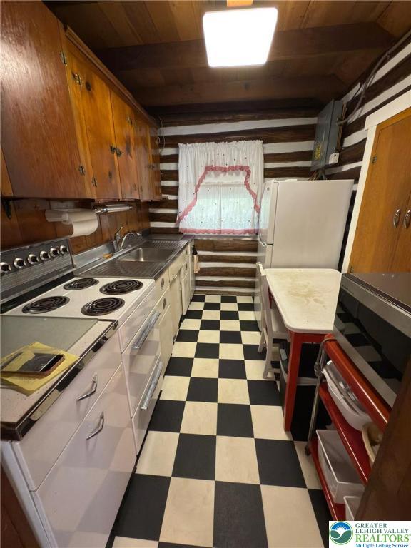521 Resica Falls Rd, East Stroudsburg, PA 18302 - kitchen featuring light floors, white appliances, wooden ceiling, and brown cabinets