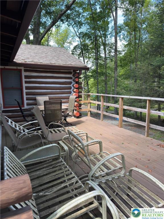 521 Resica Falls Rd, East Stroudsburg, PA 18302 - deck featuring outdoor dining space and view of scattered trees
