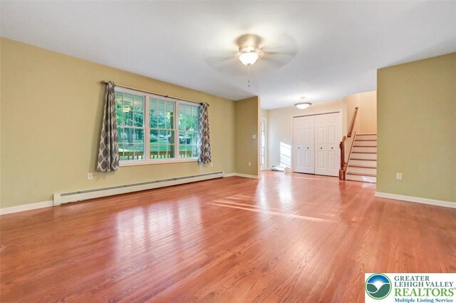 119 Savage Trl, Smithfield Twp, PA 18301 - empty room featuring baseboard heating, stairway, ceiling fan, and wood finished floors