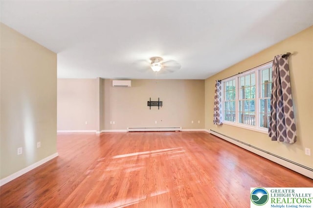 119 Savage Trl, Smithfield Twp, PA 18301 - unfurnished room with baseboard heating, an AC wall unit, ceiling fan, and light wood finished floors