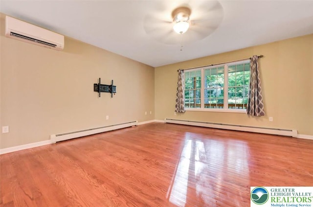 119 Savage Trl, Smithfield Twp, PA 18301 - empty room featuring a baseboard radiator, an AC wall unit, wood finished floors, and ceiling fan