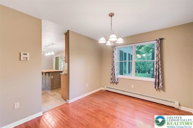 119 Savage Trl, Smithfield Twp, PA 18301 - spare room with a chandelier, baseboard heating, and light wood-style floors