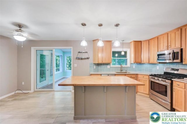 119 Savage Trl, Smithfield Twp, PA 18301 - kitchen with stainless steel appliances, butcher block counters, decorative backsplash, light brown cabinetry, and a center island