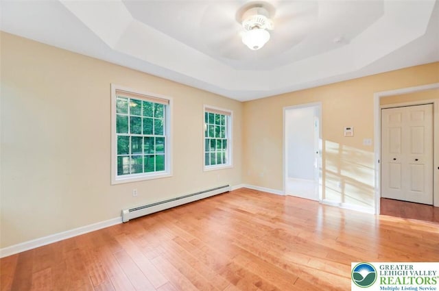 119 Savage Trl, Smithfield Twp, PA 18301 - spare room with baseboard heating, a raised ceiling, ceiling fan, and wood finished floors