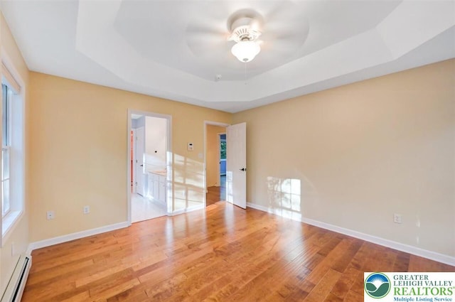 119 Savage Trl, Smithfield Twp, PA 18301 - spare room featuring a baseboard radiator, a tray ceiling, ceiling fan, and wood finished floors