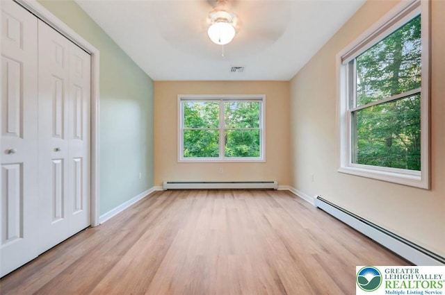 119 Savage Trl, Smithfield Twp, PA 18301 - unfurnished bedroom featuring baseboard heating, light wood-style flooring, and a closet