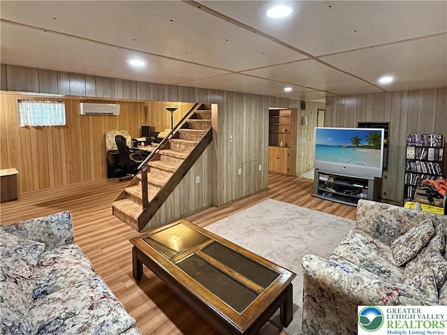 7537 Lake Shore Dr, Tobyhanna Twp, PA 18347 - living area featuring a wall unit AC, wooden walls, stairway, wood finished floors, and recessed lighting