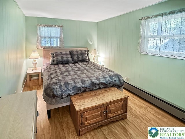 7537 Lake Shore Dr, Tobyhanna Twp, PA 18347 - bedroom featuring a baseboard heating unit and wood finished floors