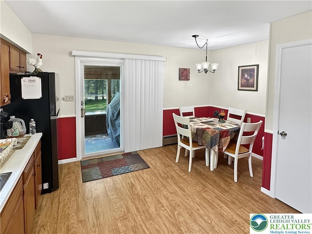 7537 Lake Shore Dr, Tobyhanna Twp, PA 18347 - dining room featuring a chandelier, light wood-style flooring, and a baseboard radiator